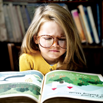 Cute and adorable little girl with glasses getting stressed out