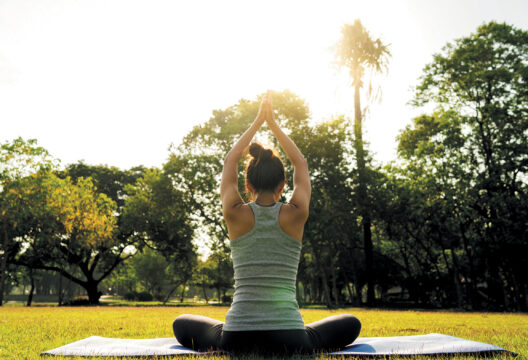 Young asian woman yoga outdoors keep calm and meditates while pr