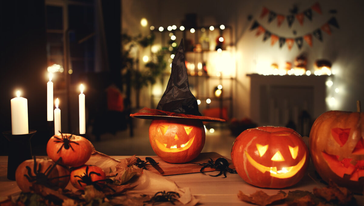 Dark interior of house decorated for Halloween pumpkins, webs and spiders